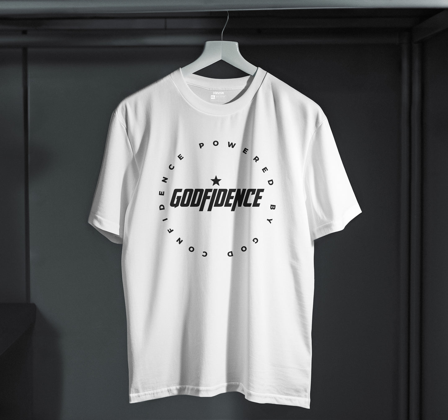 White t-shirt with 'GODFIDENCE' logo on a hanger against a dark background