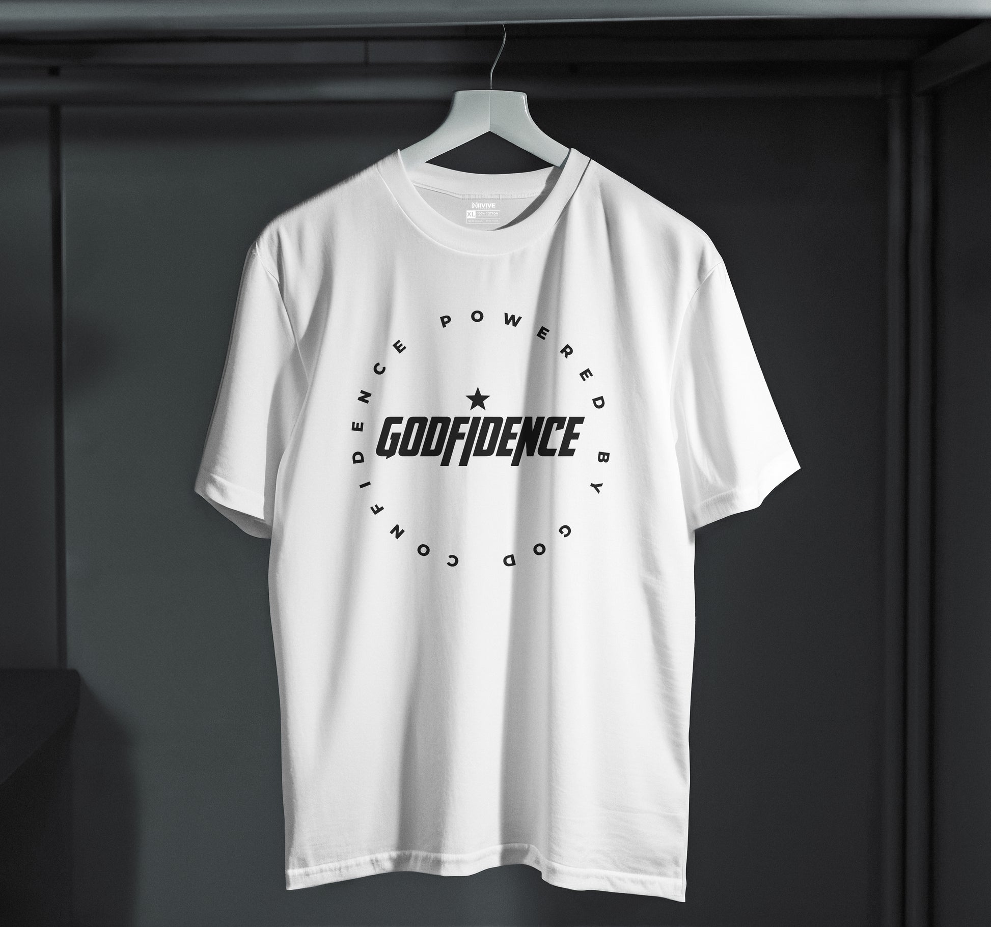 White t-shirt with 'GODFIDENCE' logo on a hanger against a dark background